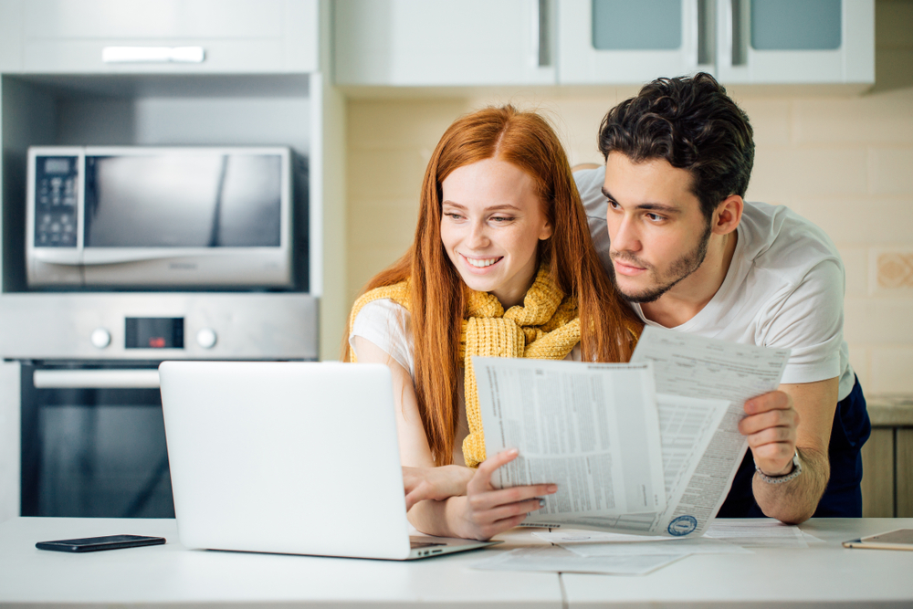 tax personal finance photo via couple looking at their finances on laptop