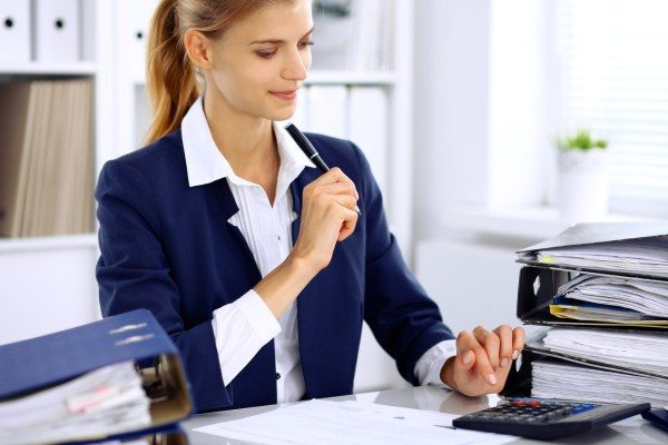 audit and advisory accountant services via women sitting at desk doing work