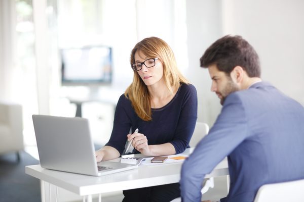 accountant audit and advisory photo via women ad man doing work at a desk