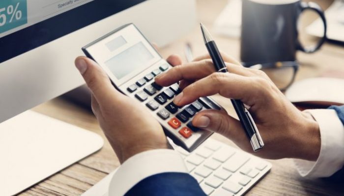 company taxation photo via person using calculator